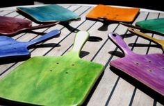 colorful wooden cutting boards sitting on top of a table