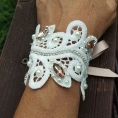 Gorgeous Lace Rhinestone Cuff Bracelet Accented With Pearls And Champagne Rhinestone Brooches. This Bracelet Measures 5.5" And Has Champagne Satin Ribbon Ties For Adjustment To Fit Most Wrists. Https://Www.Etsy.Com/Shop/Countryjourney Vintage White Bracelets For Wedding, Handmade White Cuff Bracelet For Weddings, Glamorous Rhinestones Cuff Bracelet For Wedding, Handmade Victorian Cuff Bracelet For Wedding, Elegant Rhinestone Wedding Cuff Bracelet, Bracelet Corsage, Lace Cuff Bracelet, Swarovski Pearls Bracelet, Tahitian Pearl Bracelet