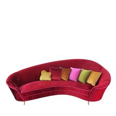 a red curved couch with many pillows on it's back and sides, in front of a white background