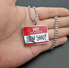 a person holding a red and white tag with the words my name is sul shady on it