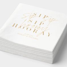 a stack of white napkins with gold foil on them that says sip sip library