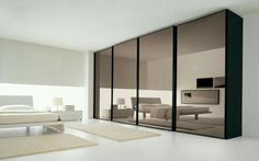 an empty bedroom with mirrored doors and white carpeted flooring is pictured in this image