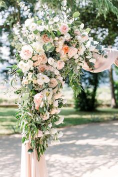 a wedding arch decorated with flowers and greenery