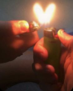 someone holding a lighter in their hand with the light on it's side,