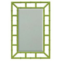 a green bamboo frame mirror on a white wall