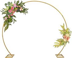 a circular gold frame with flowers and leaves on it, as well as a golden stand