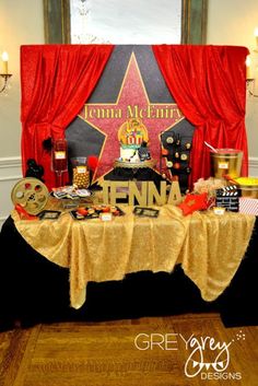 the table is set up for an event with decorations and film reels on it