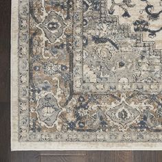 an area rug with various colors and designs on it, including blue, beige, orange and