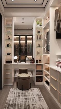 a walk in closet with lots of shelves and drawers