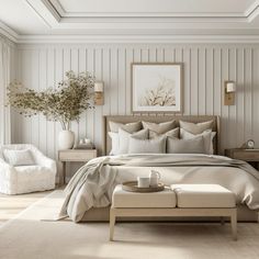 a bed sitting in a bedroom next to a white chair and table with a vase on it