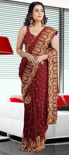 Red and Maroon color Saree in Georgette fabric with Stone work Red Floor-length Saree With Cutdana, Red Floor-length Cutdana Saree, Red Georgette Floor-length Saree, Red Georgette Embroidered Fabric For Designer Wear, Elegant Red Embroidered Fabric With Dori Work, Fitted Red Saree For Reception, Red Chinon Dupatta For Reception, Red Traditional Wear With Pallu For Reception, Red Saree For Diwali Reception