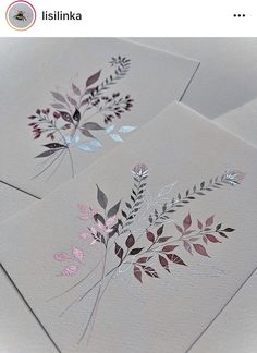 three cards with floral designs on them sitting next to each other, one is pink and the other is blue