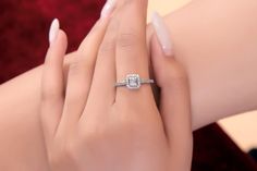 a woman's hand with a diamond ring on it