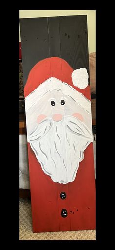 a cardboard santa clause is sitting on the floor