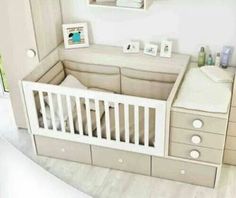 a baby's room with a crib, dresser and changing table in it