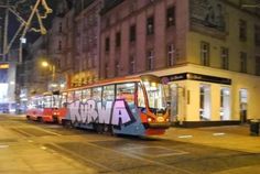 a bus that is sitting on the side of the road in front of some buildings