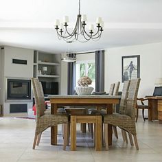 a dining room table with chairs and a chandelier