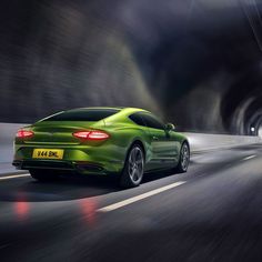 a green sports car driving through a tunnel