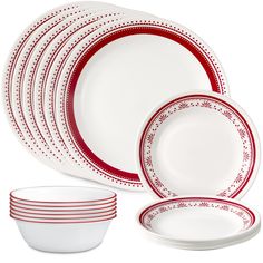 the red and white dinnerware is set on top of each other with matching dishes