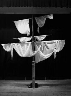 a black and white photo of a boat made out of cloths on a pole