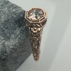 a fancy ring is sitting on top of a rock