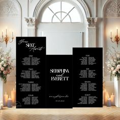 an elegant black and white wedding seating plan is displayed on a wooden table with candles