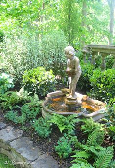 a small fountain in the middle of a garden