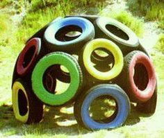 an outdoor sculpture made out of tires in the grass