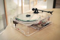 a turntable sitting on top of a wooden table