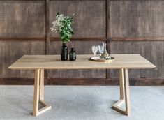 a wooden table with two vases on it