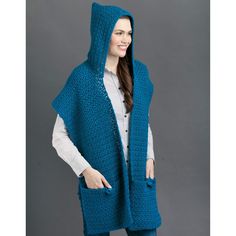 a woman wearing a blue crocheted hooded cape