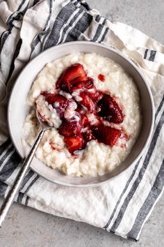 a bowl of oatmeal with strawberries on top