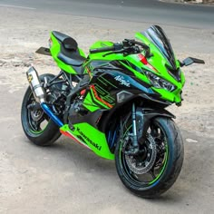 a green and black motorcycle parked on the street