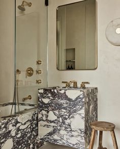 a marble sink and mirror in a bathroom