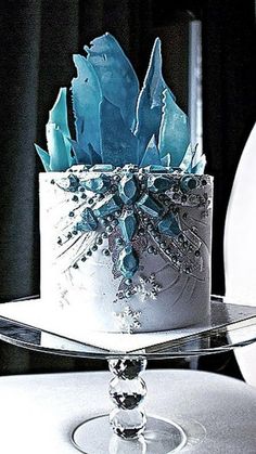 a white cake with blue frosting on top