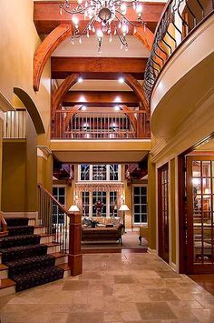 a large foyer with chandelier and stairs leading up to the second floor area