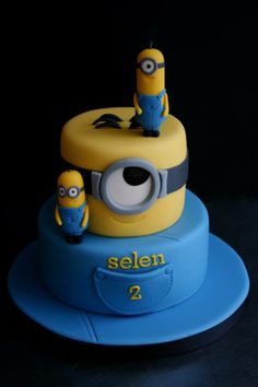 a birthday cake with two minion characters on it