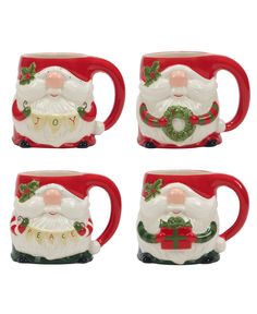 four christmas mugs with santa clause on them