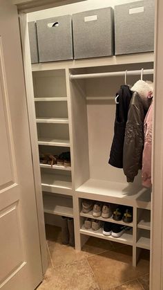 an organized closet with shoes and coats hanging on the shelves, along with other storage bins