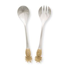 two silver and gold spoons with pinecones on the sides, one is empty