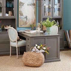 a home office with blue walls and furniture