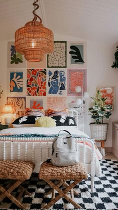 a bedroom decorated in orange, white and black with pictures on the wall above the bed