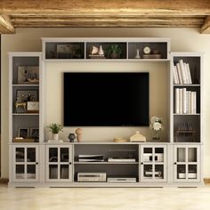 a living room with white furniture and a flat screen tv on top of a entertainment center