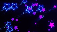 many pink and blue stars on a black background