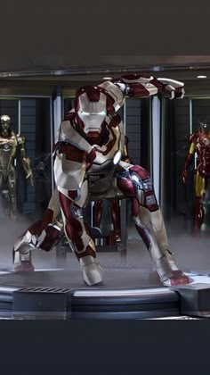 the iron man suit is on display in front of other costumes