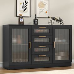 a black cabinet with glass doors and gold handles in the corner of a living room