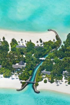 an aerial view of a tropical island in the middle of the ocean with palm trees