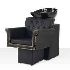 a black chair with gold trimmings and a bowl on the back