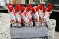 red and white napkins tied together in a metal holder on a marble counter top