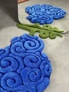 two blue rugs sitting on the floor next to each other in front of a mirror